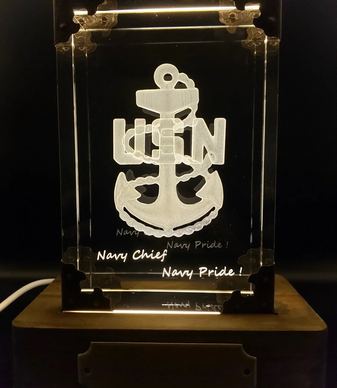 Illuminated 3D acrylic sign with Navy emblem, anchor, and text reading 'Navy Chief' and 'Navy Pride!' on a wooden base.