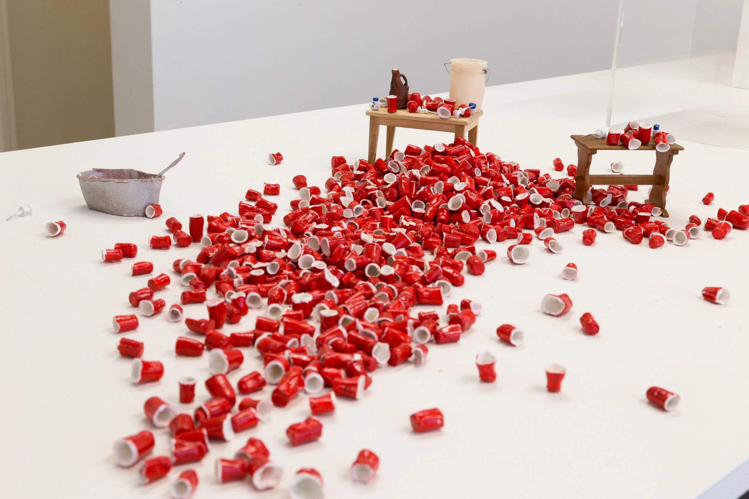 909 Solo Cups, 2017
mixed media
dimensions variable


The 909 solo cups, at first glance, resemble a scene of a riotous frat party, but actually portrays the
Jonestown massacre led by the charismatic cult leader Jim Jones. The 909 cups found at Jones