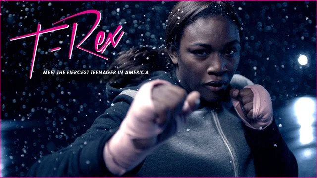 A young woman in a hoodie with her fists raised in a fighting stance, surrounded by rain or water droplets, with text that reads 'F-ck' and 'Meet the fiercest teenager in America'.