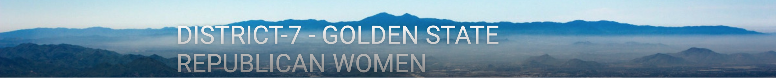 A mountain range with a blue sky and some clouds in the background.