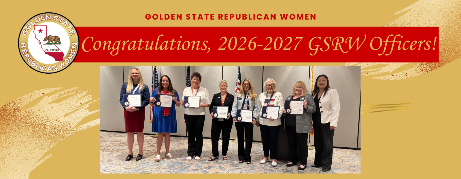 A group of women standing on a stage holding certificates, celebrating their appointment as GSRW officers for 2026-2027, with a banner and flags in the background.
