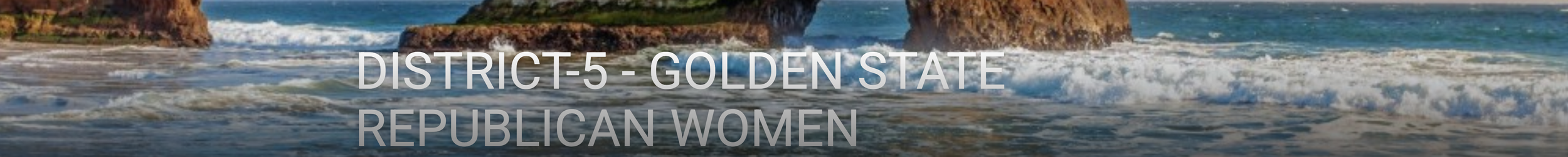 Coastal scene with waves crashing against rocks and cliffs on the shore, under a clear sky.