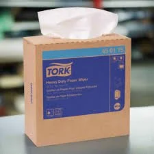 Box of Tork heavy-duty paper hand towels with tissue pulling out from the top