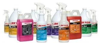 Assorted bottles of cleaning or chemical products in various colors and sizes, including spray bottles and containers.