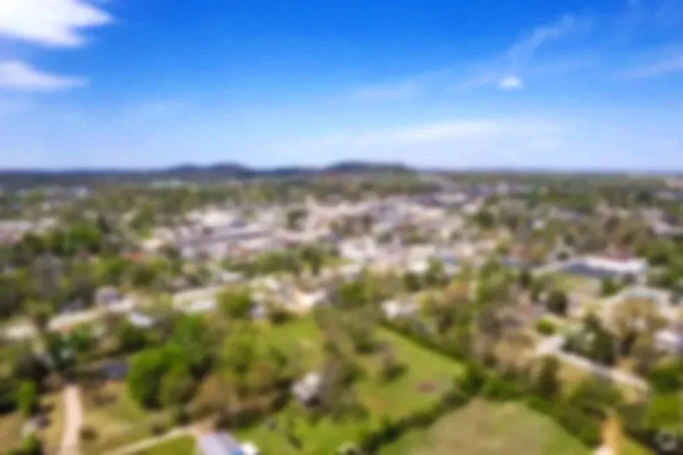 Arial Image of Mountain Home, AR. Image is blurry and used as a background to the page title.