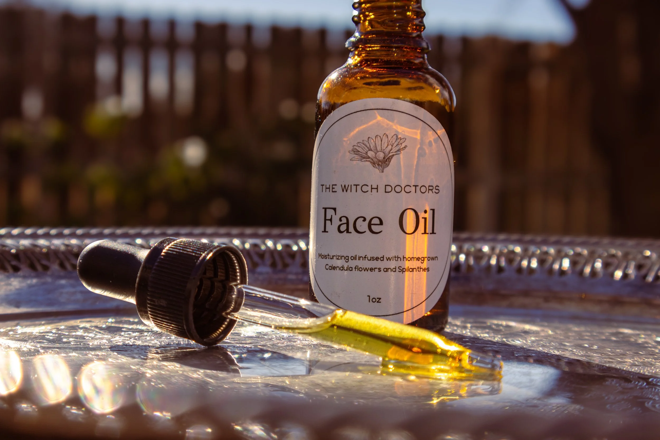 A golden liquid oil for nourishing and moisturizing face and skin treatment named Face oil by the Witch Doctors- 100% natural and handmade 