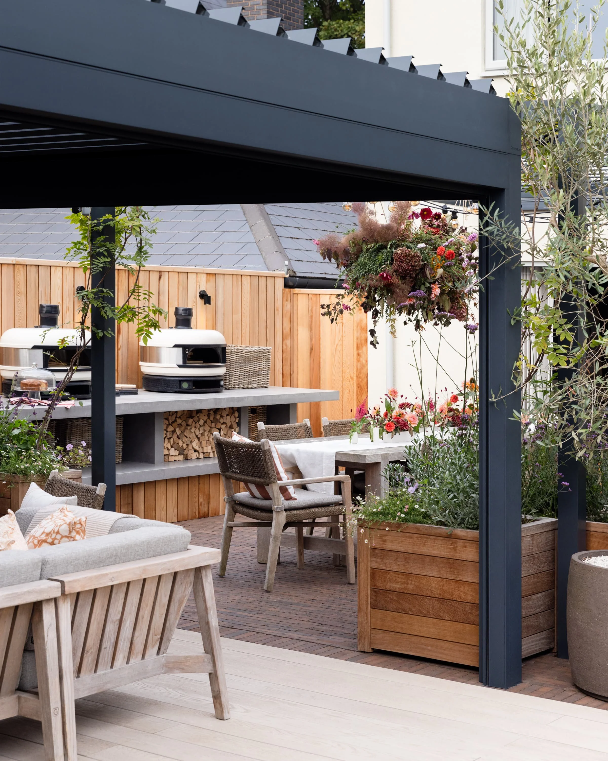 Shaded pergola with outdoor fireplace providing a sheltered retreat for gatherings