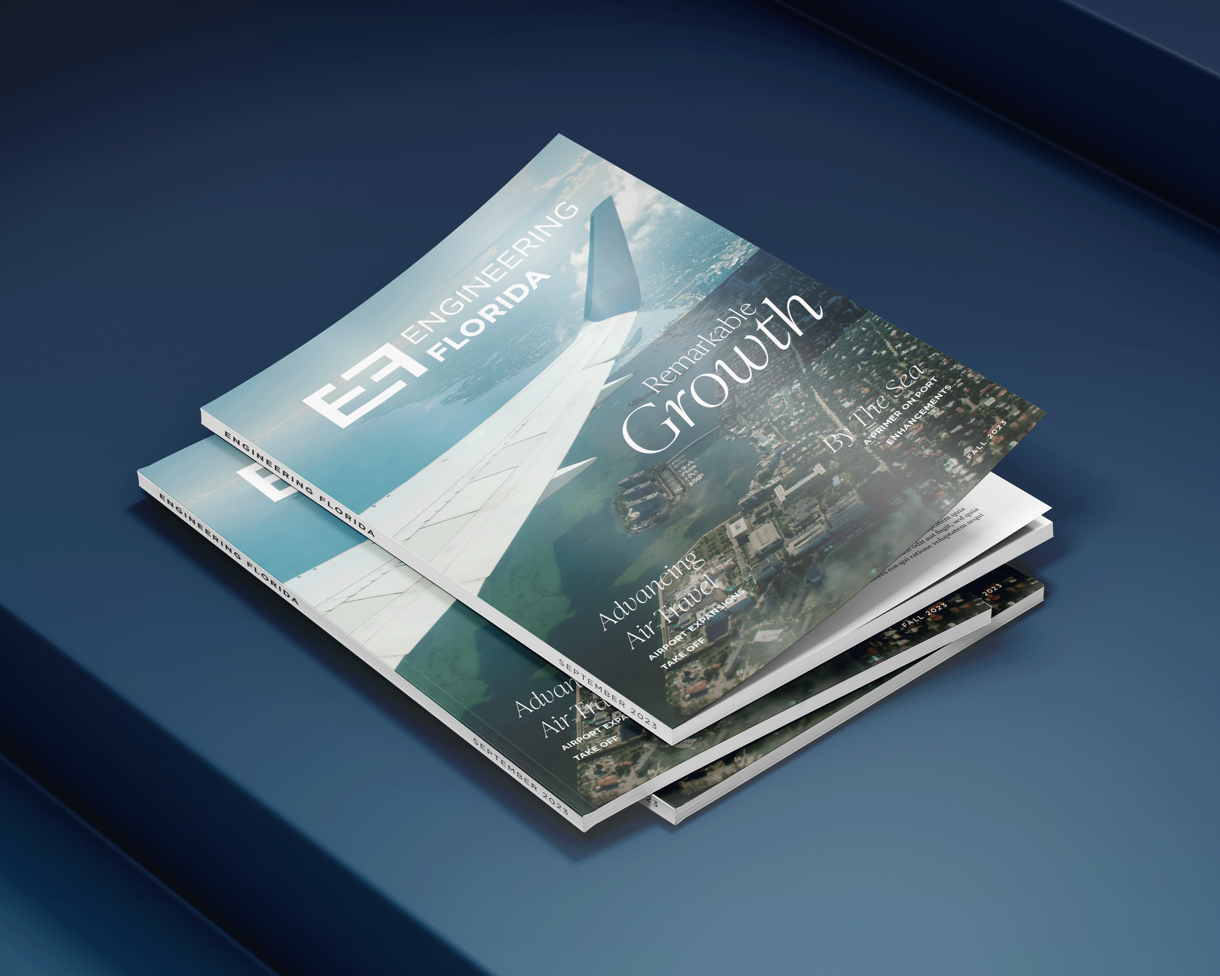 Stack of three Engineering Florida magazine featuring aerial views of a city and an airplane wing on the cover.
