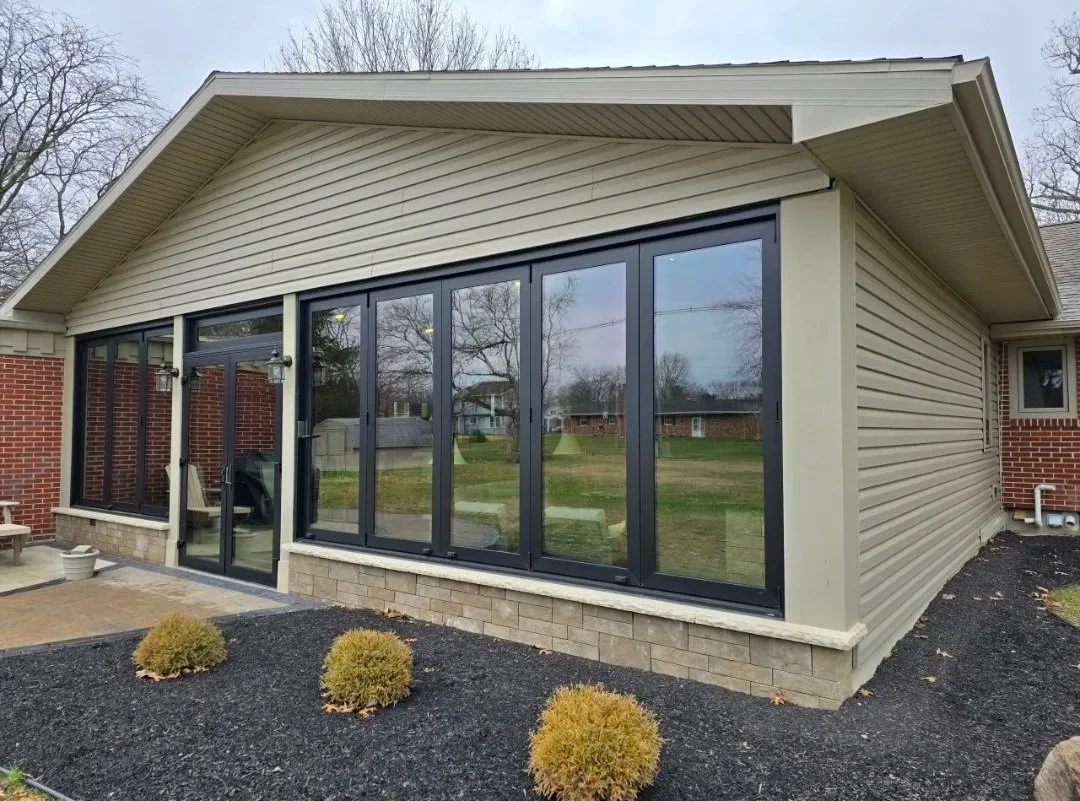 overhead structure with bi-fold windows and screens with a landscape design