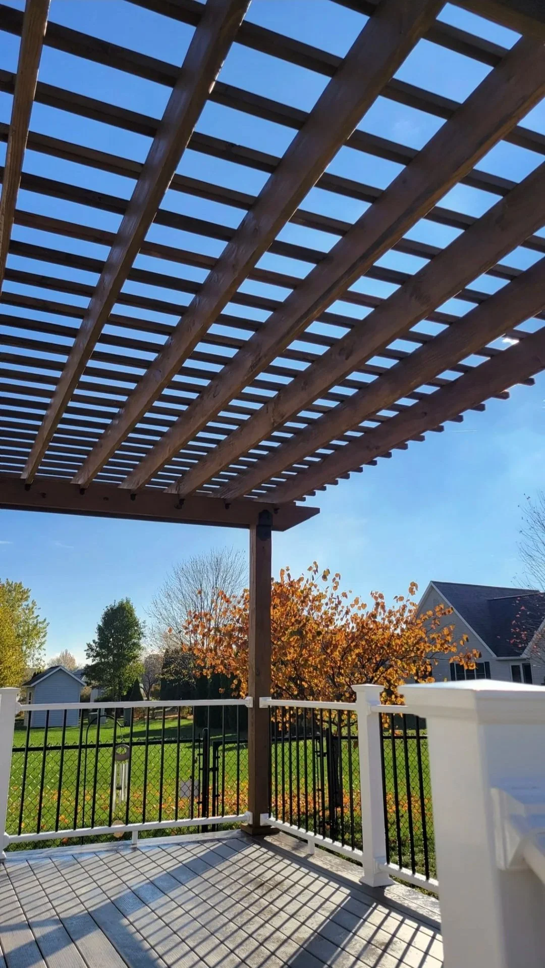 Composite deck with handcrafted wooden stained pergola