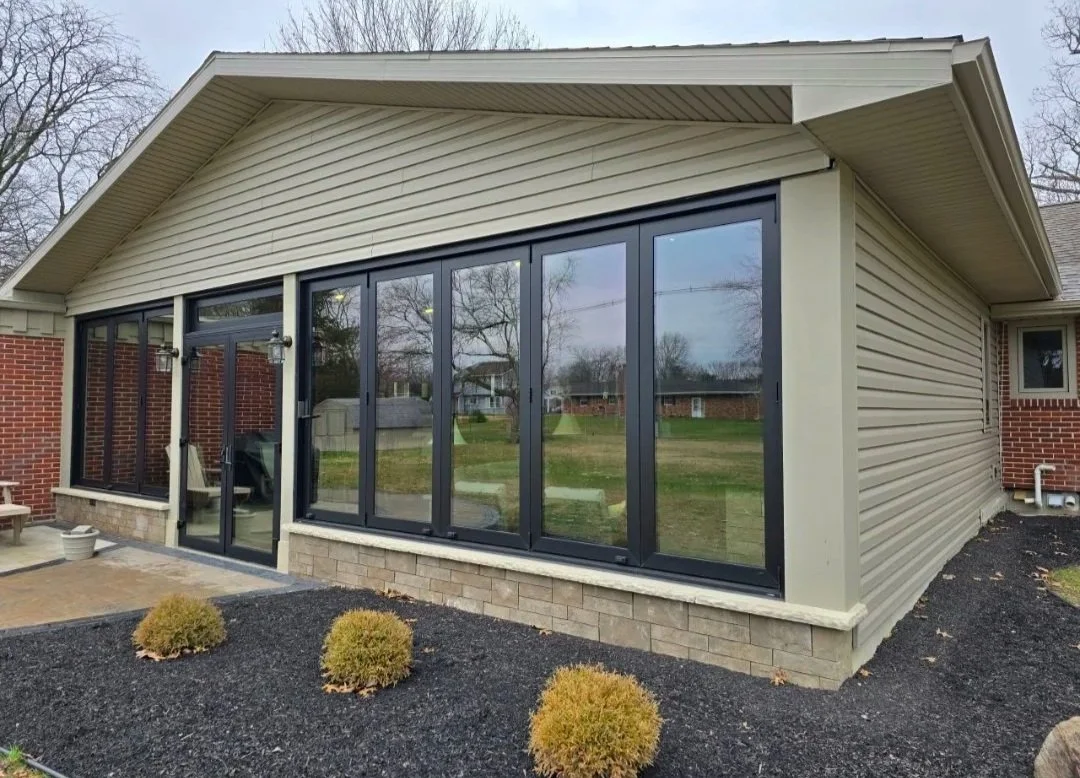 Outdoor living space with bi-fold windows with screens