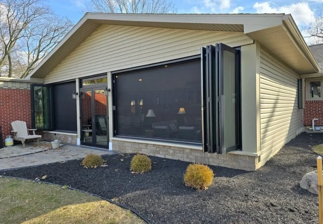 Outdoor living space with bi-fold windows with screens