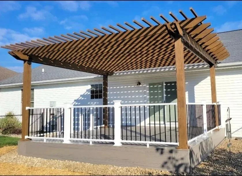 Composite deck with handcrafted stained wooden pergola