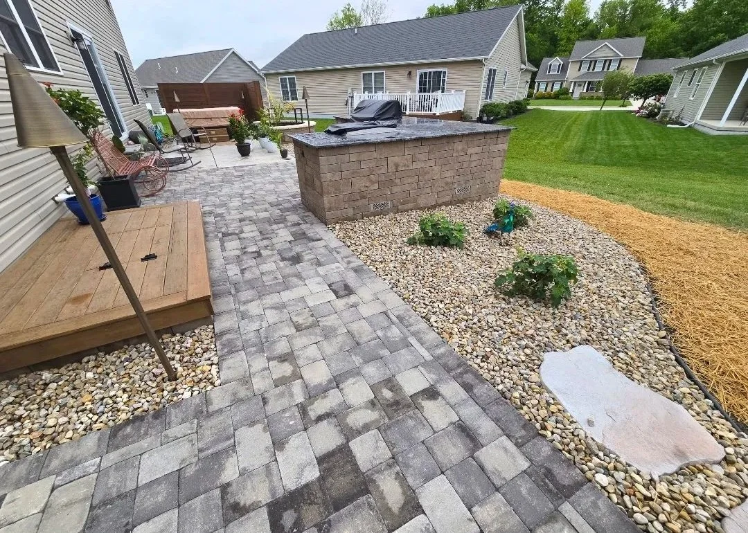 Outdoor living space with unilock camelot pavers and techo-bloc brandon wall grill island. summerset grill and griddle. 