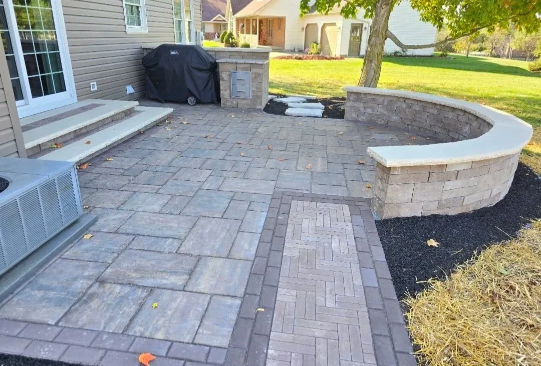 outdoor paver patio using unilock mattoni, holland premier and beacon hill flagstone pavers with decorative seat wall and grill island in wapakoneta ohio