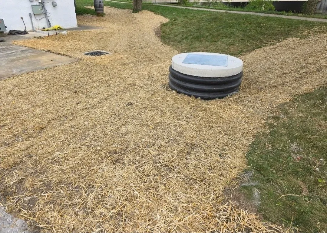 grading and seeding around a sump pump pit