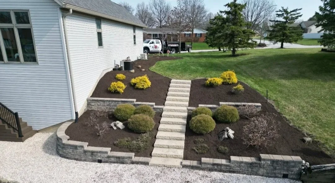 retaining walls with staircase with a landscape design with mulch