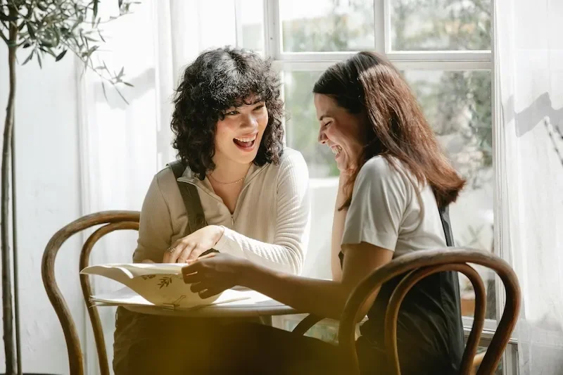 women smiling in cafe together