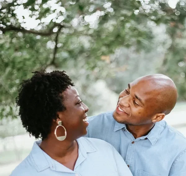 couple outdoors smiling at each other