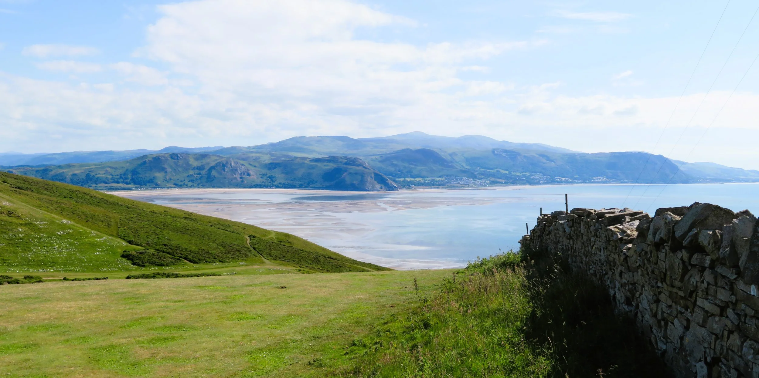 Green slopes of the Great Orme above Llandudno, looking out over the coast and the mountains beyond