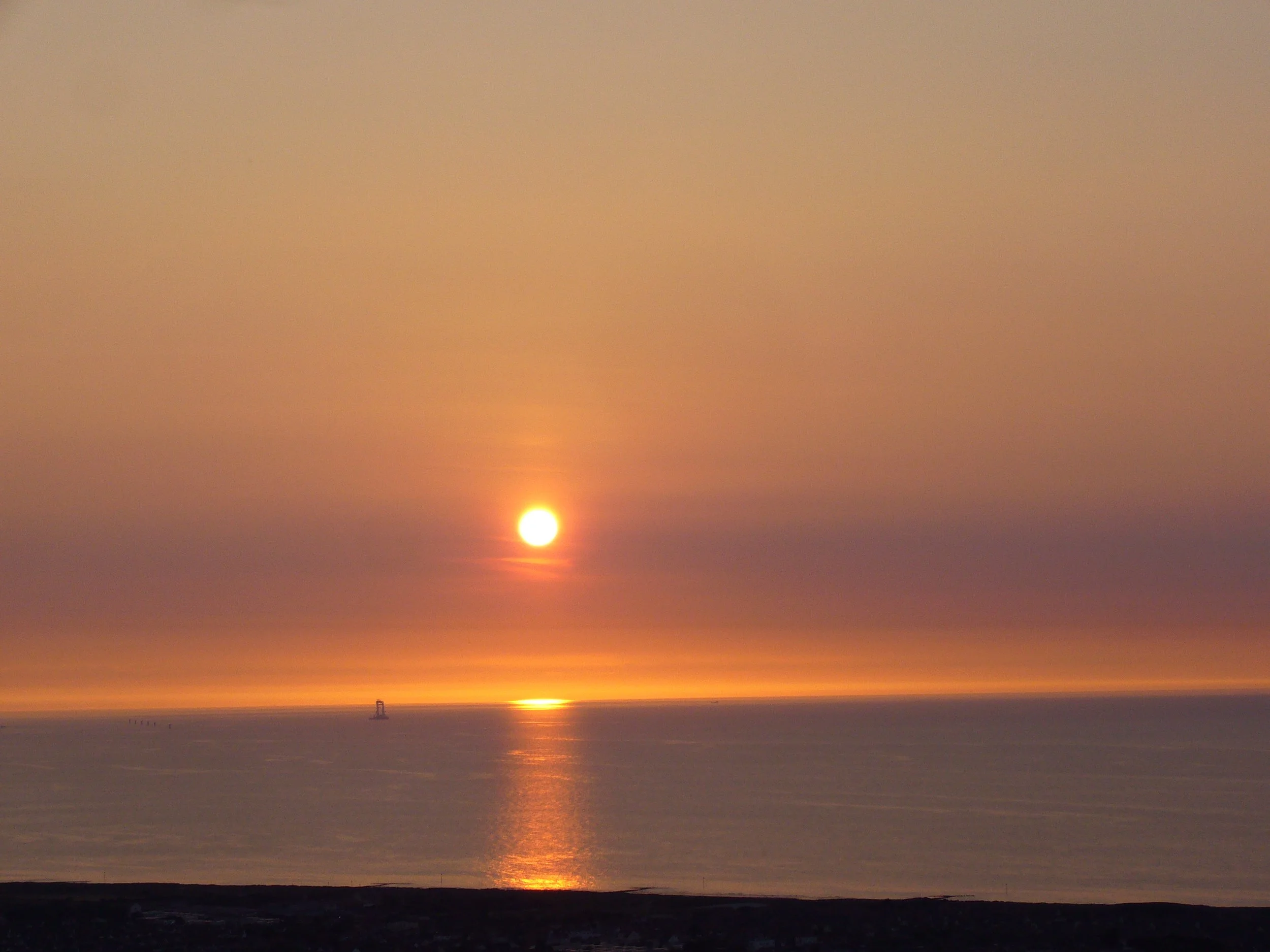 Sun setting over a calm sea at Prestatyn
