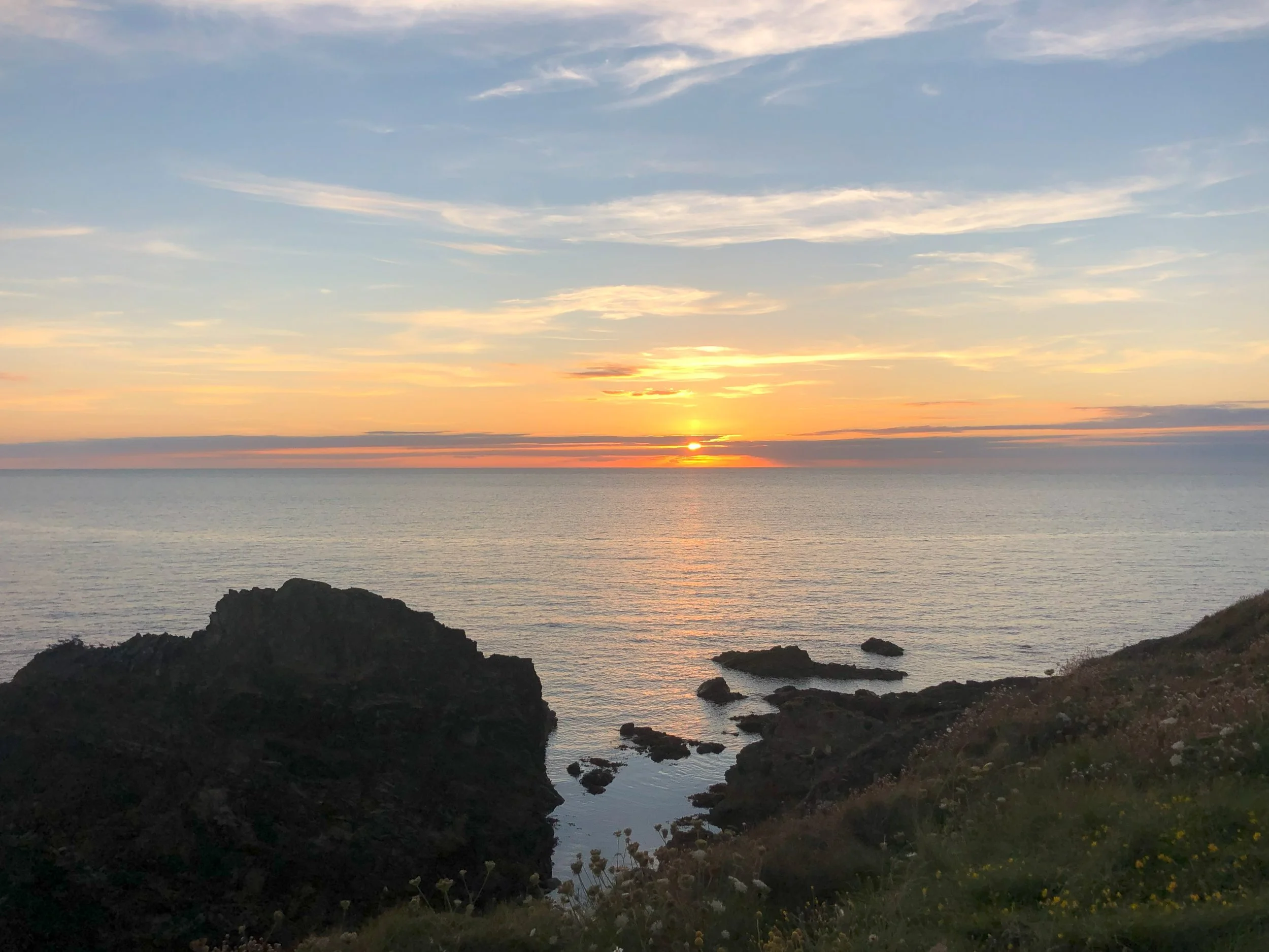 Sunset over the sea and rocks at Aber Geirch on the Llŷn Peninsula