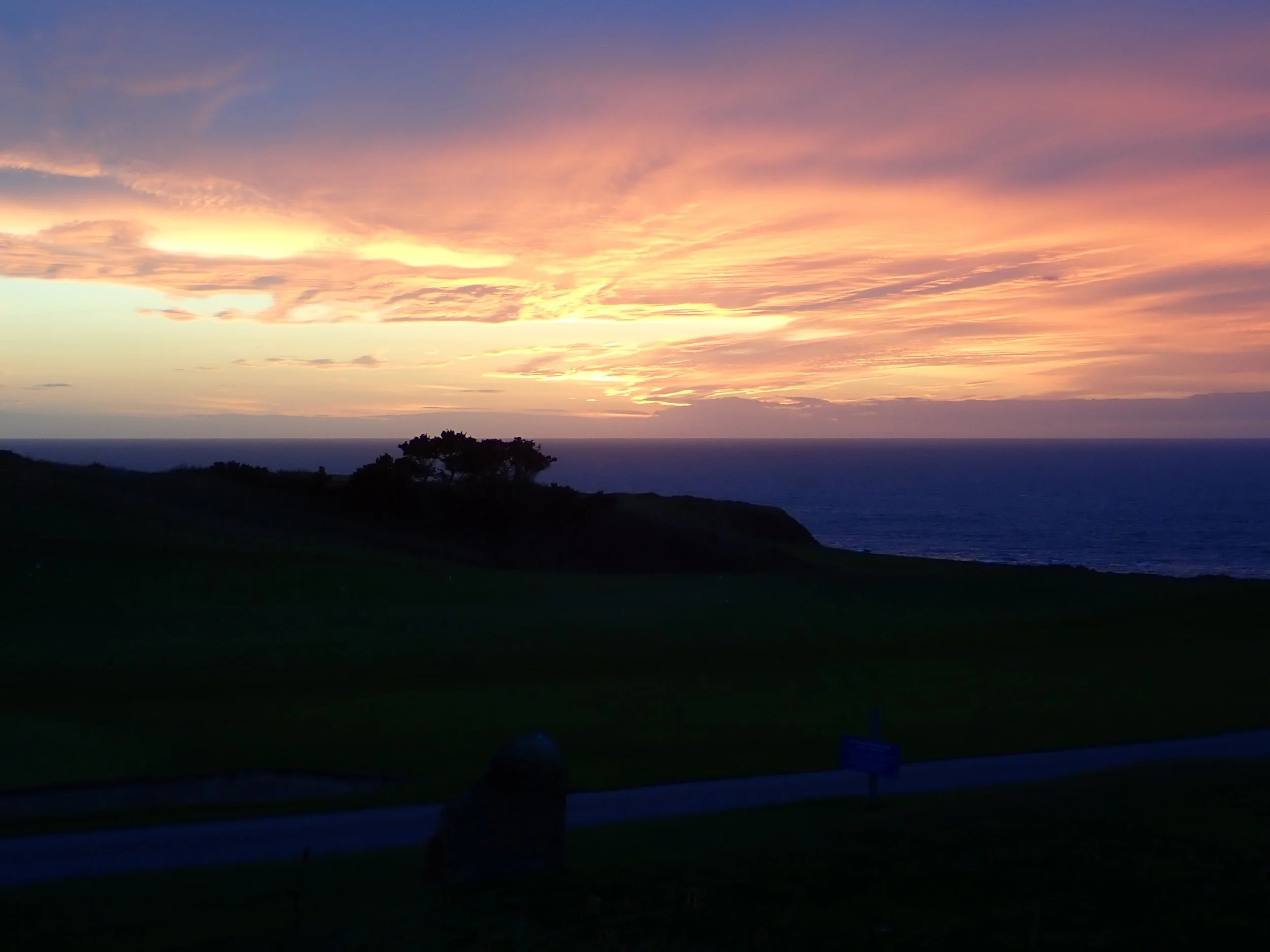 Pink and gold sunset over the coast at Morfa Nefyn on the Llŷn Peninsula