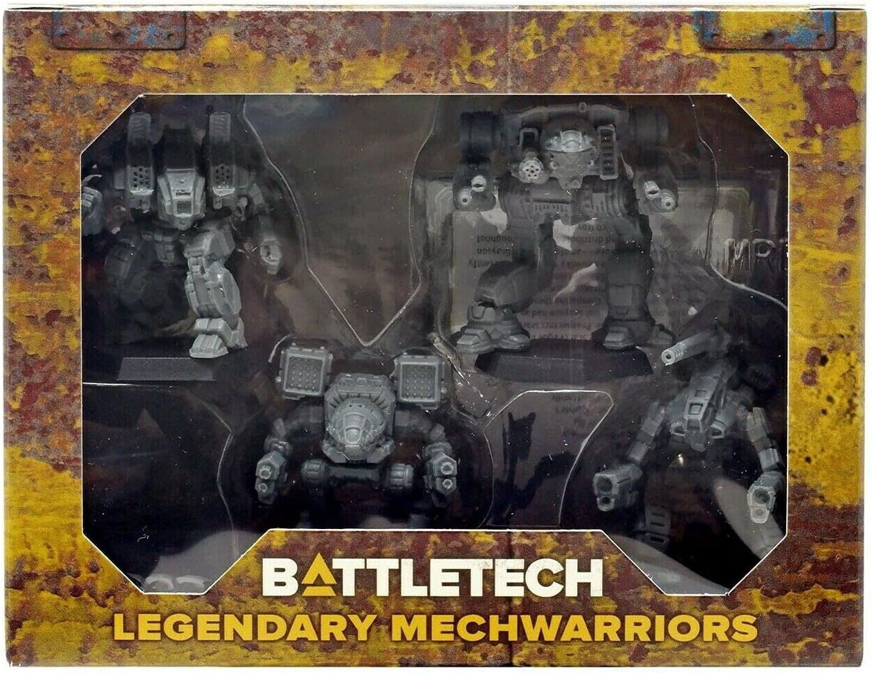 Box containing four gray military-style mech warrior figures with weapons, labeled 'Battletech Legendary Mechwarriors'.