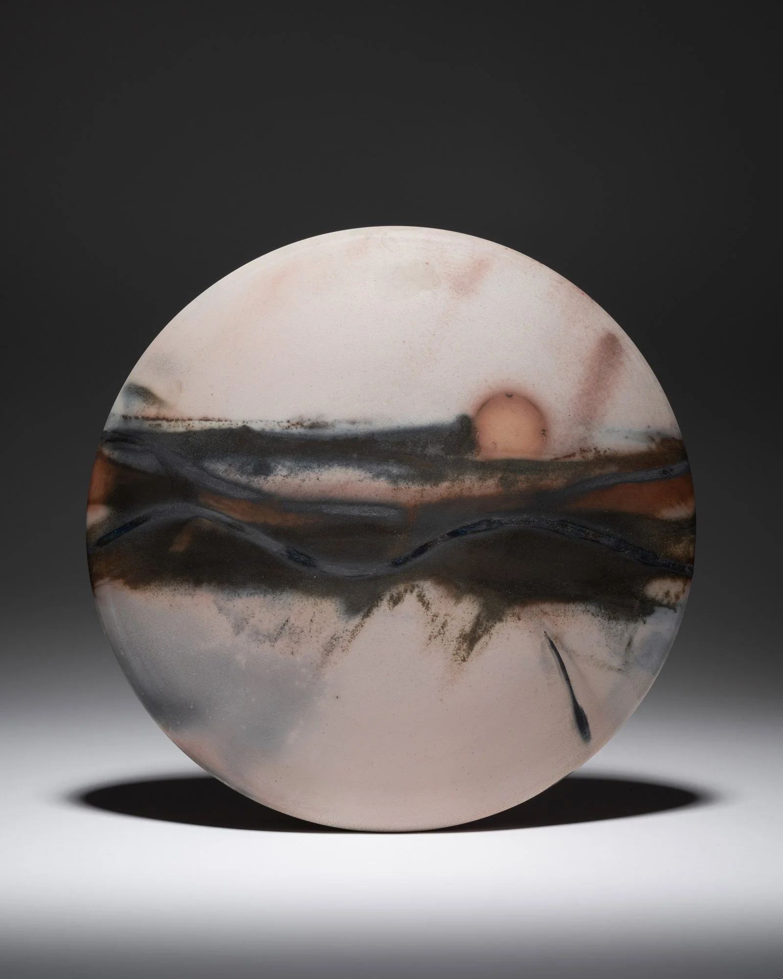 ´Windswept´ 2024, Medium Wall Disc
White Stoneware Clay, Thrown & Saggar Fired with West Cork sawdust, seaweeds, recycled wires & oxides 
(H) x (L) x (W)  
24.5 cm x 24.5 cm x 3cm