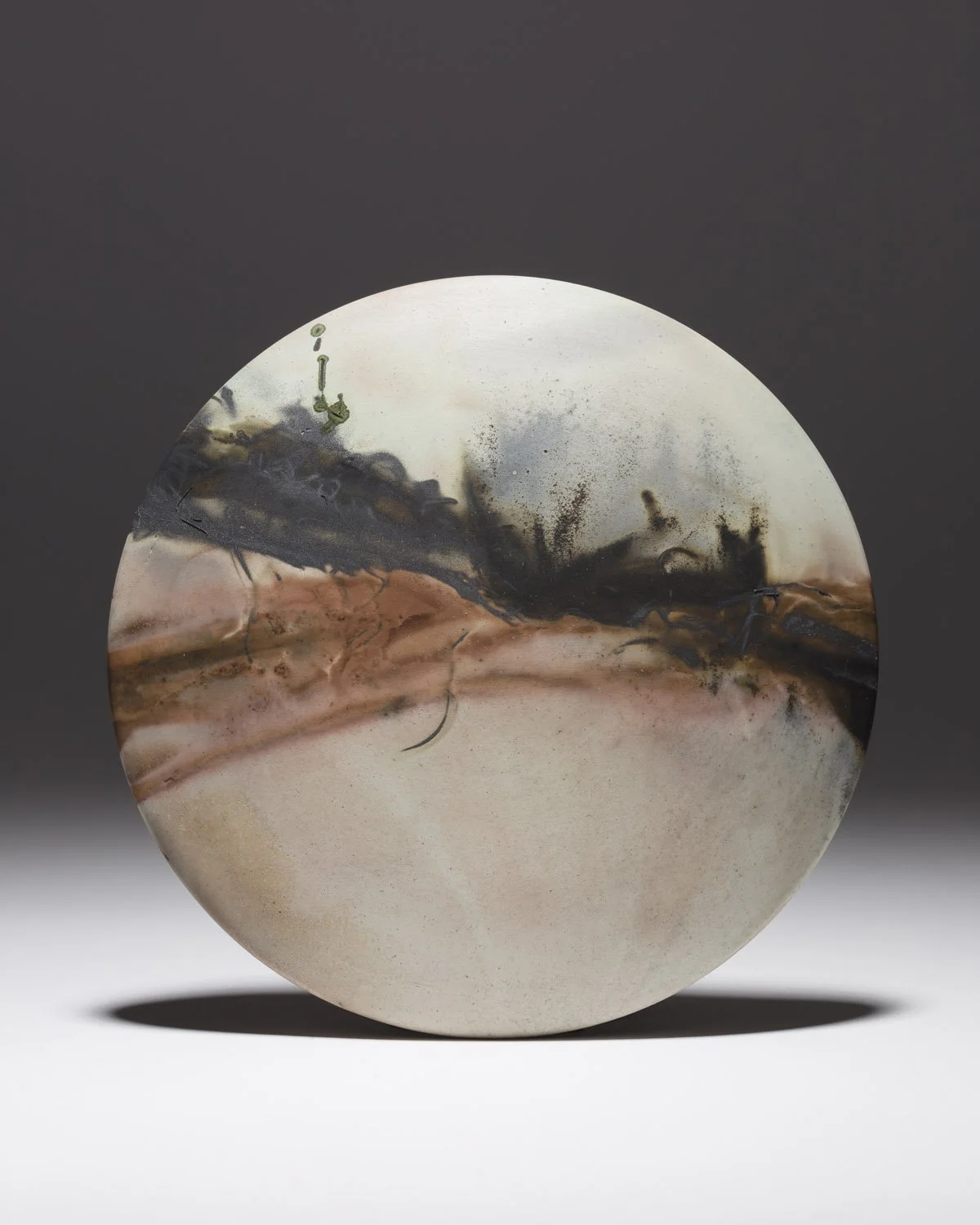 ´Impact´ 2022, Smallie Wall Disc
White Stoneware Clay, Thrown & Saggar Fired with West Cork sawdust, seaweeds, recycled wires & oxides 
(H) x (L) x (W)
17 cm x 17 cm x 2.5 cm