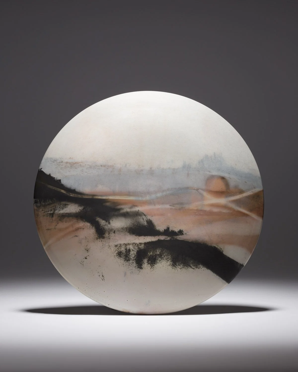 ´Chalk Trails´ 2022, Medium Wall Disc
White Stoneware Clay, Thrown & Saggar Fired with West Cork sawdust, seaweeds, recycled wires & oxides
(H) x (L) x (W) 
25.5 cm x 25. cm x 2.5 cm