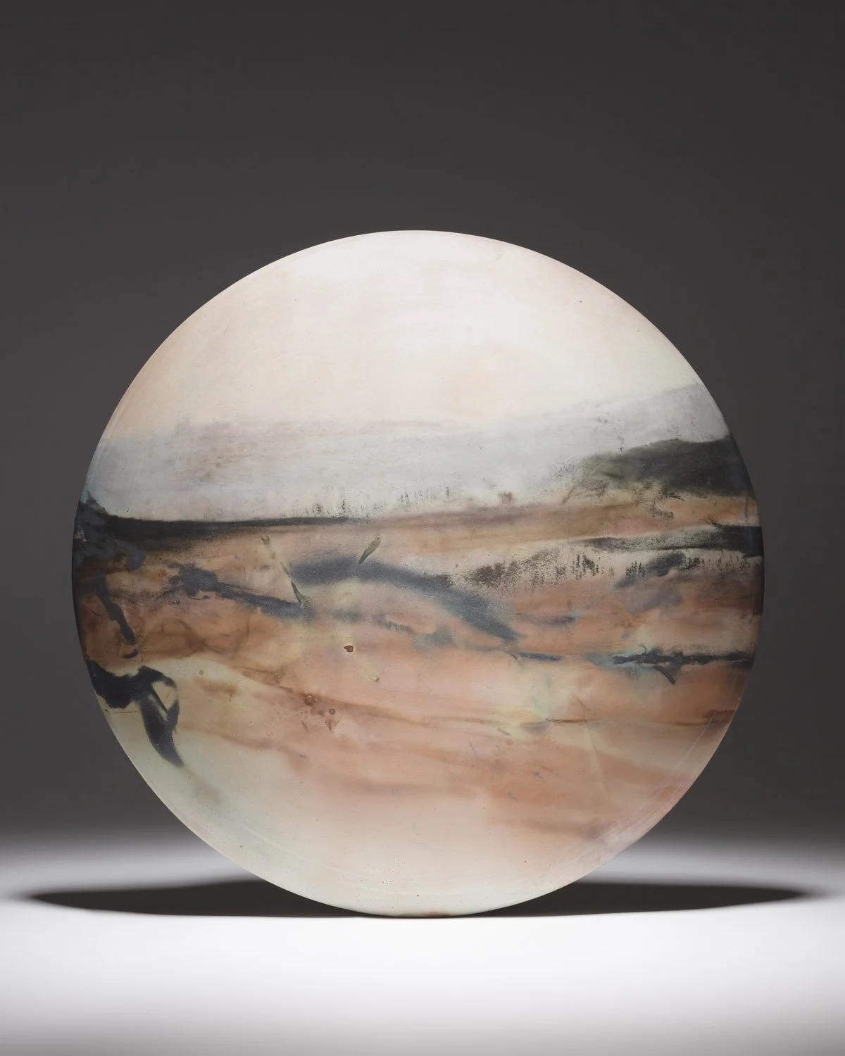 ´Parched Earth I´ 2022, XXl Wall Disc
White Stoneware Clay, Thrown & Saggar Fired with West Cork sawdust, seaweeds, recycled clay & oxides
(H) x (L) x (W)
 34 cm x 34 cm x 3.5 cm