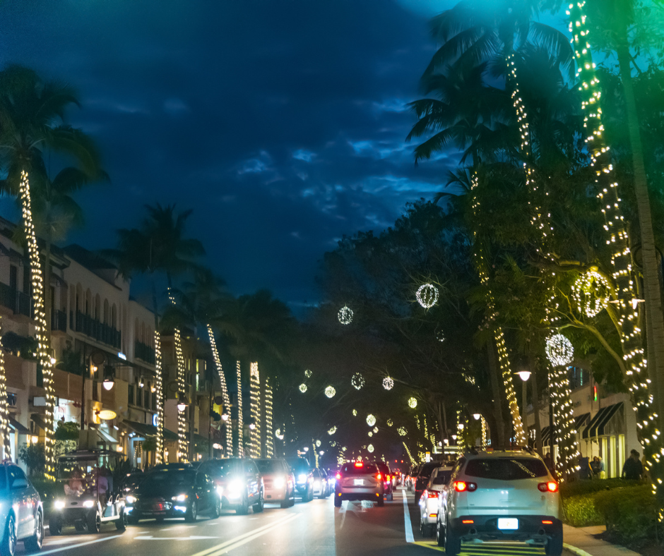 cars driving down the street of 5th Ave in Naples, FL and seeing the christmas lights