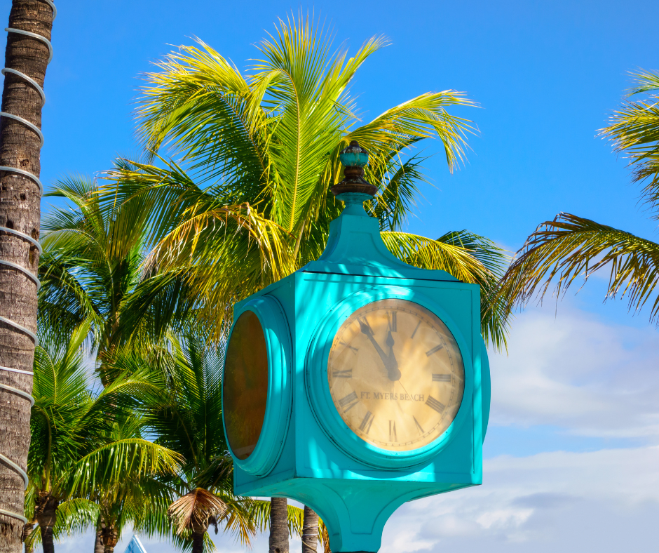 image of the clock tower on Fort Myers Beach in Florida with palm trees in the background