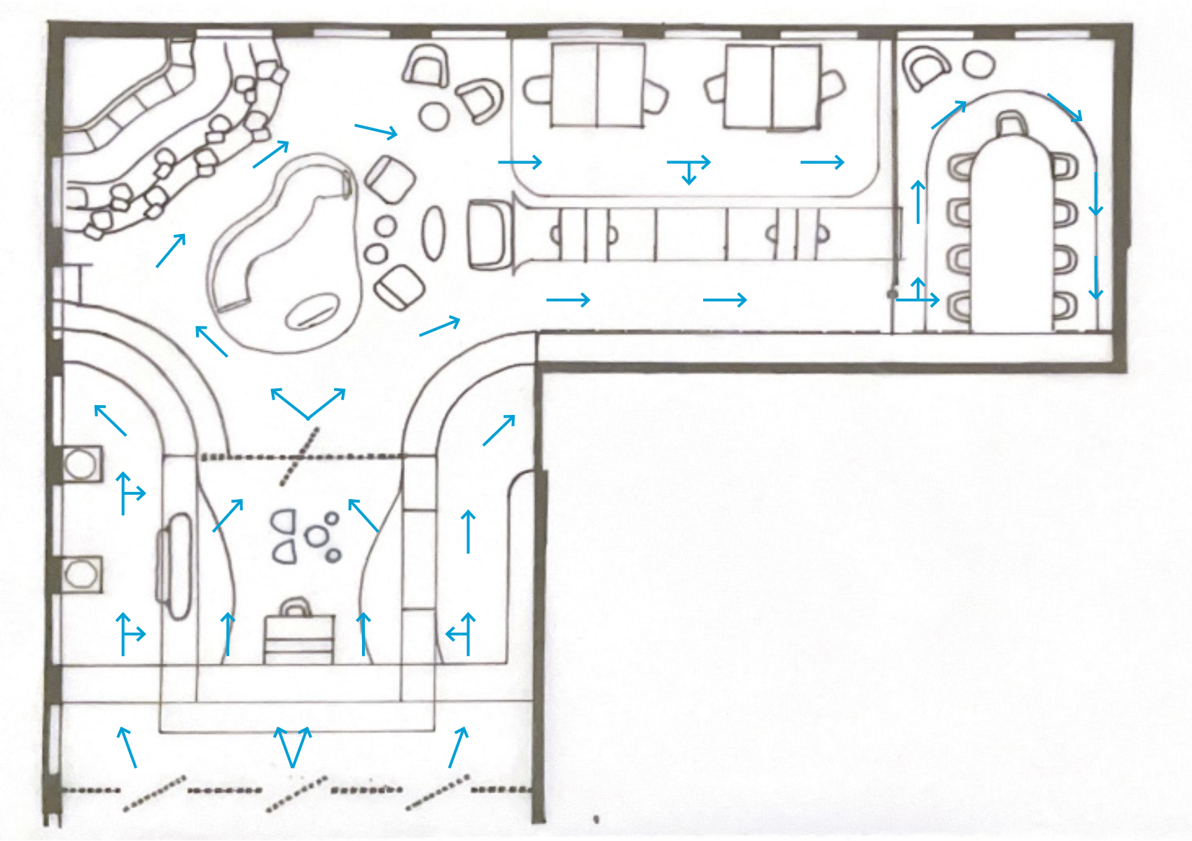 Floor plan of an indoor play area with a slide, climbing structures, seating areas, and a large table with chairs.