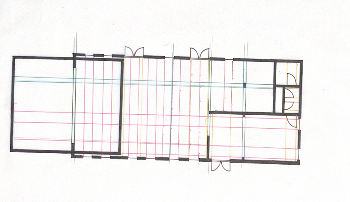 Floor plan of a building with multiple rooms and doors.