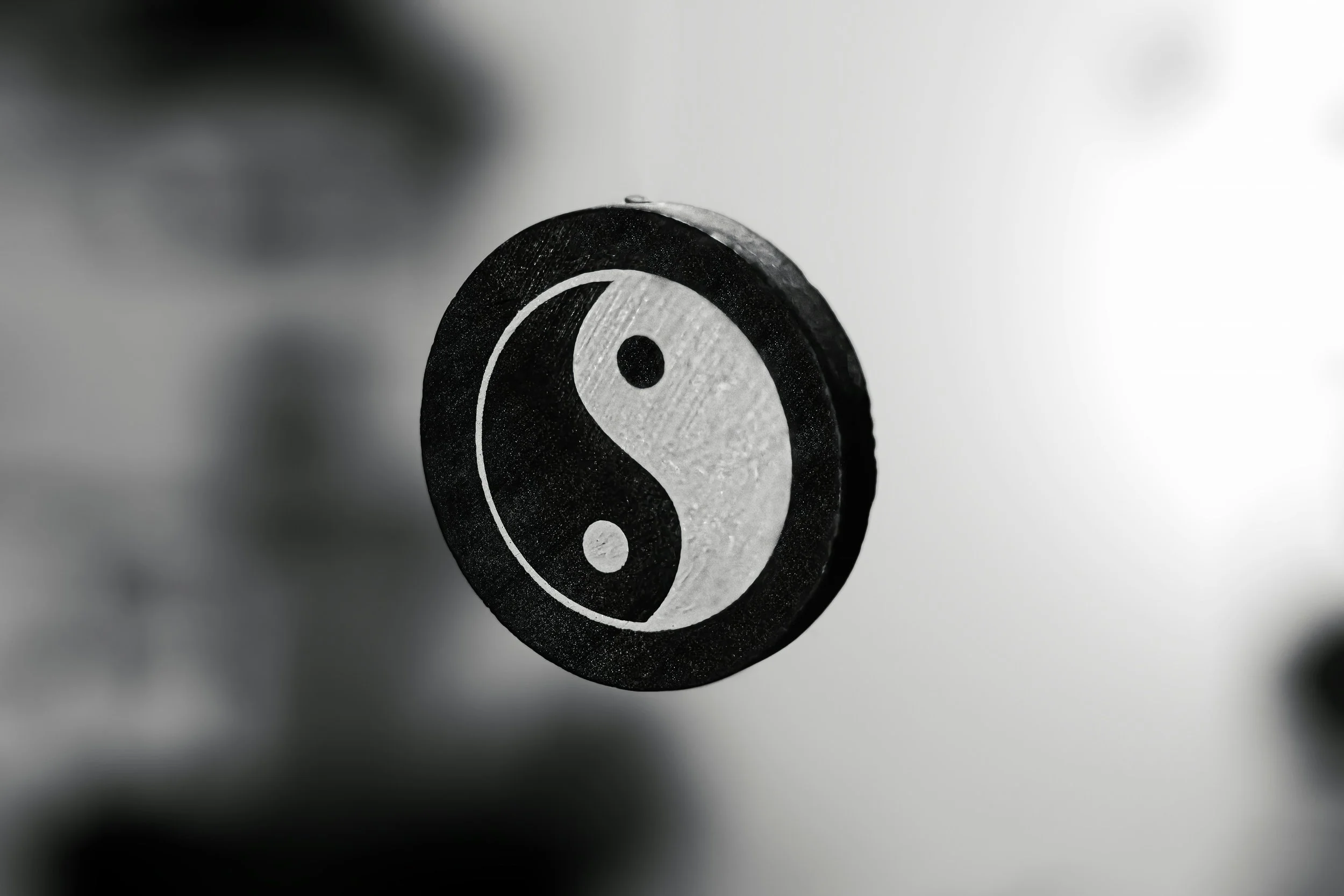 A black and white Yin-Yang symbol, floating in the air.
