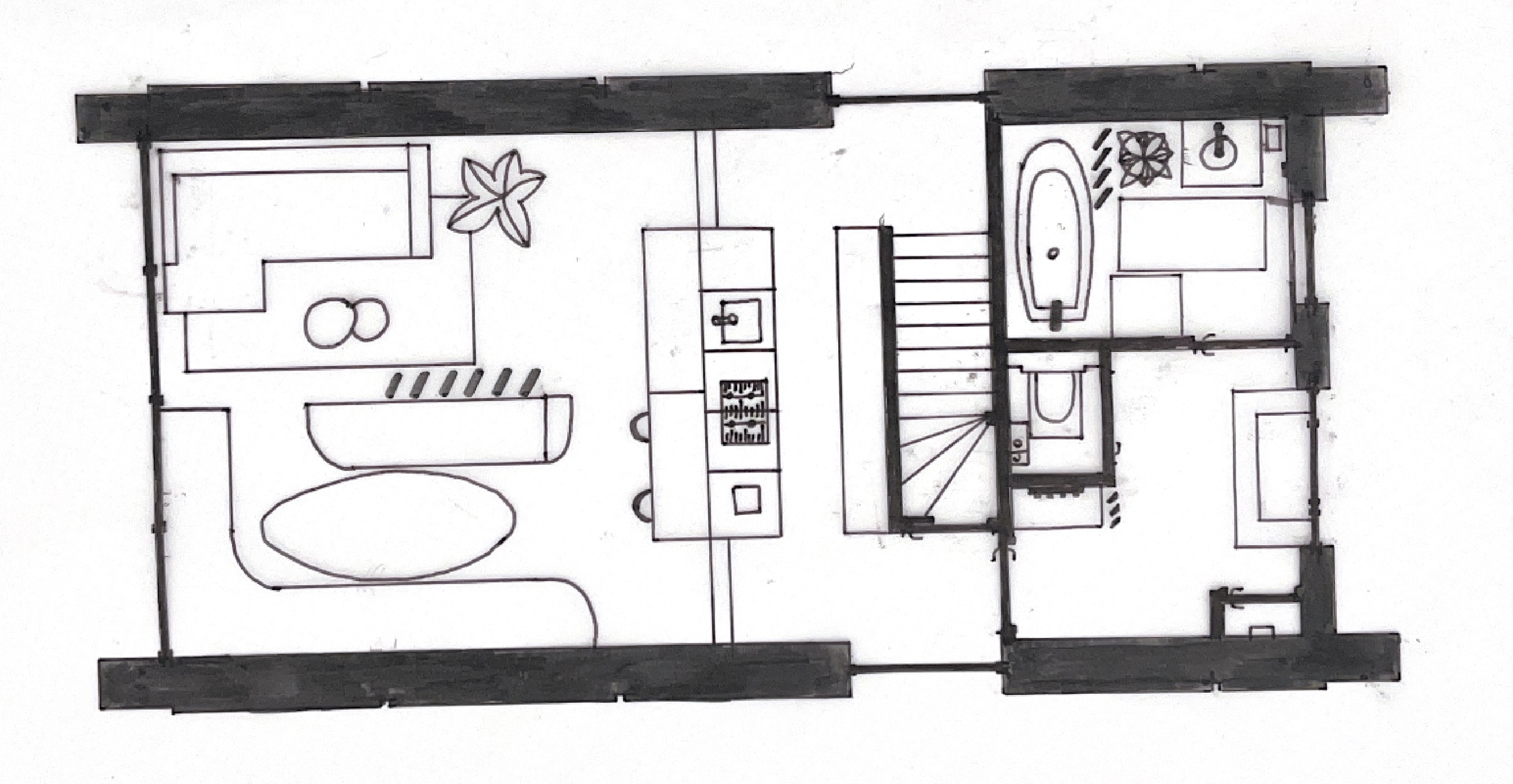 Floor plan of a house showing a bathroom with a bathtub, a staircase, a kitchen with a stove and sink, and a living area with furniture.