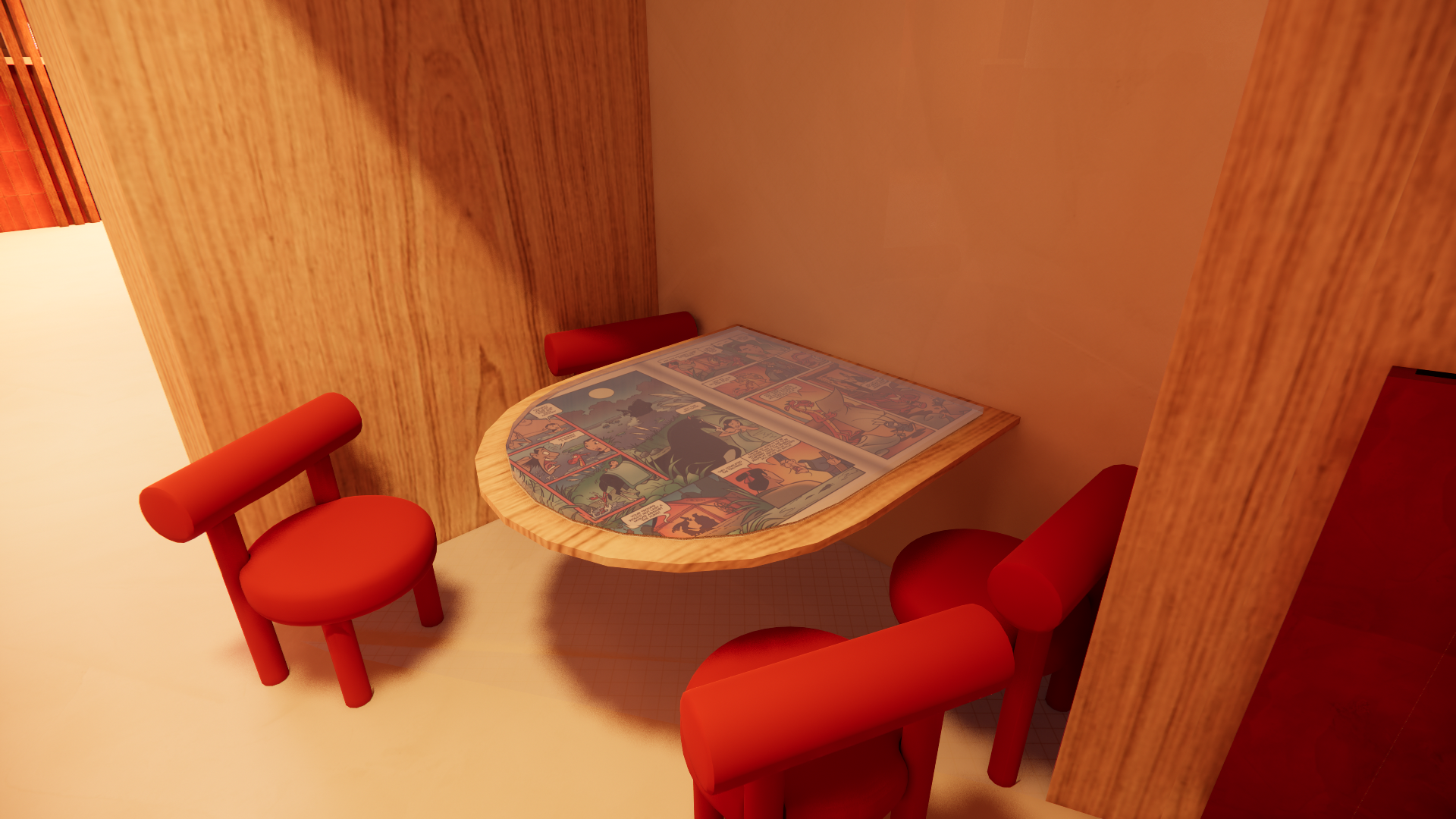A small wooden table with two red chairs, with comic book pages laid out on the table, inside a room with wooden walls.