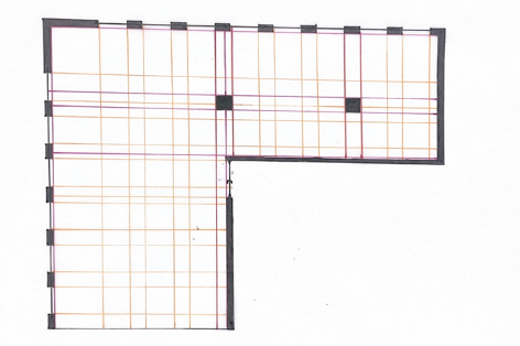 Architectural floor plan of a building with gridlines and walls.