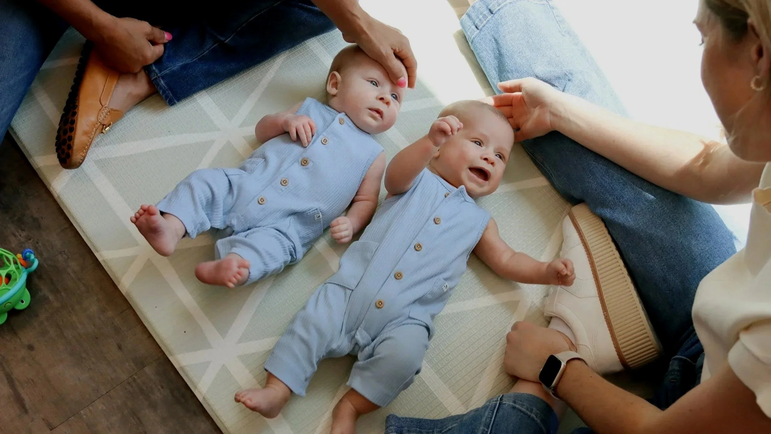 Twin infants lay on a mat as they are evaluated for pediatric therapy in the Looking Ahead office in Franklin, TN