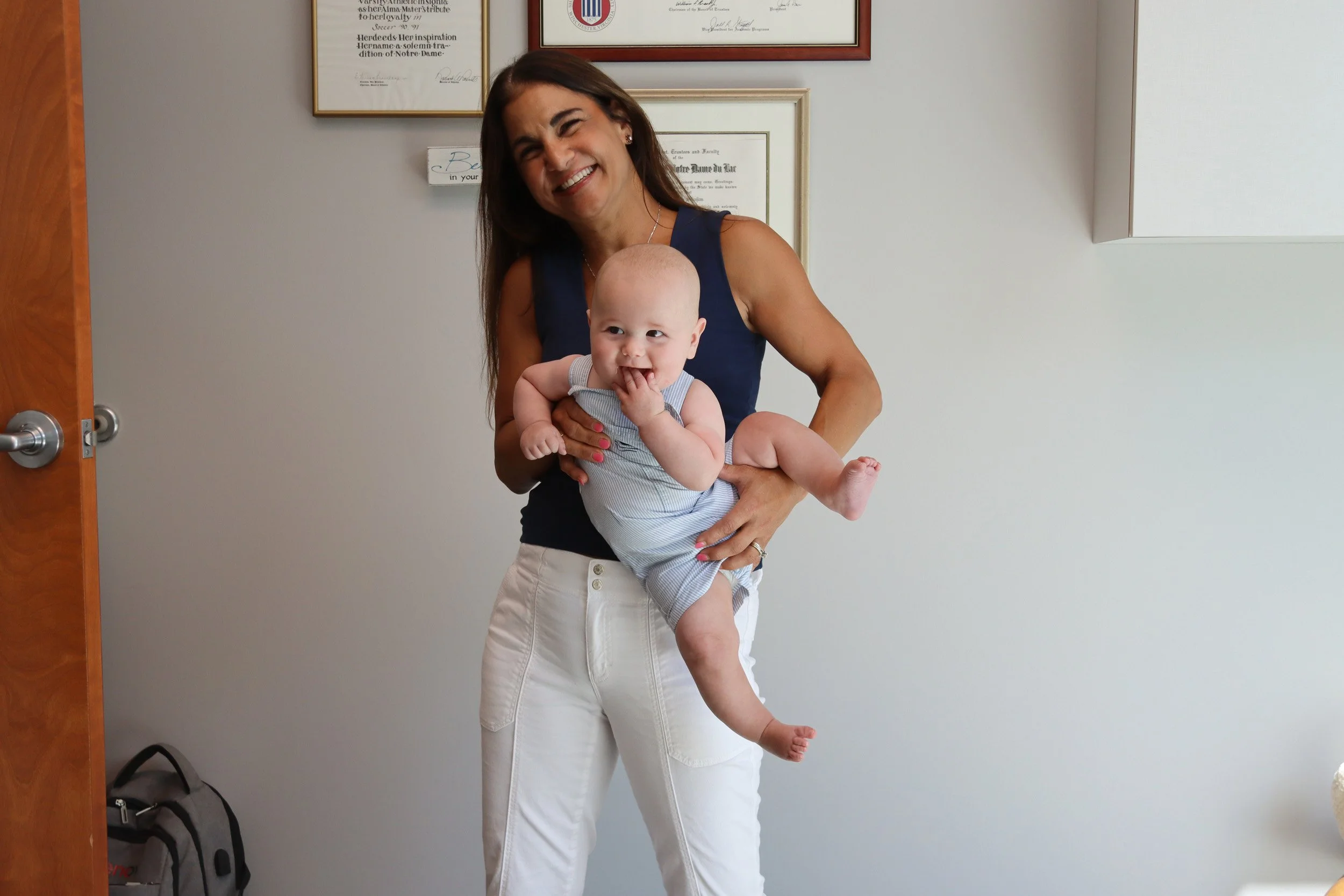 Andrea Callanen, owner of Looking Ahead Pediatric Therapies, smiles as she holds a baby in her Franklin, TN office