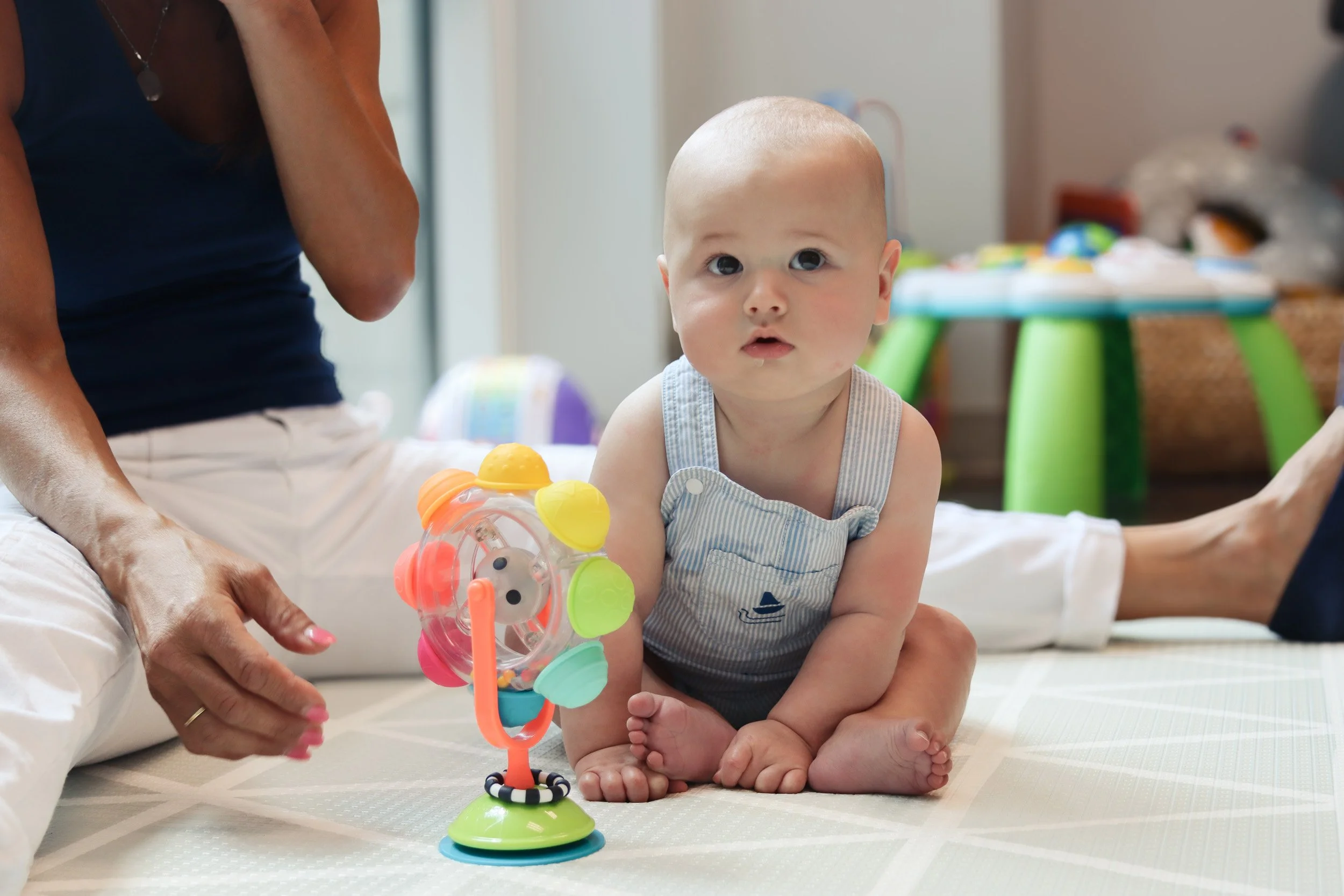 An infant sits independently with a toy as part of his torticollis treatment at Looking Ahead in Franklin, TN