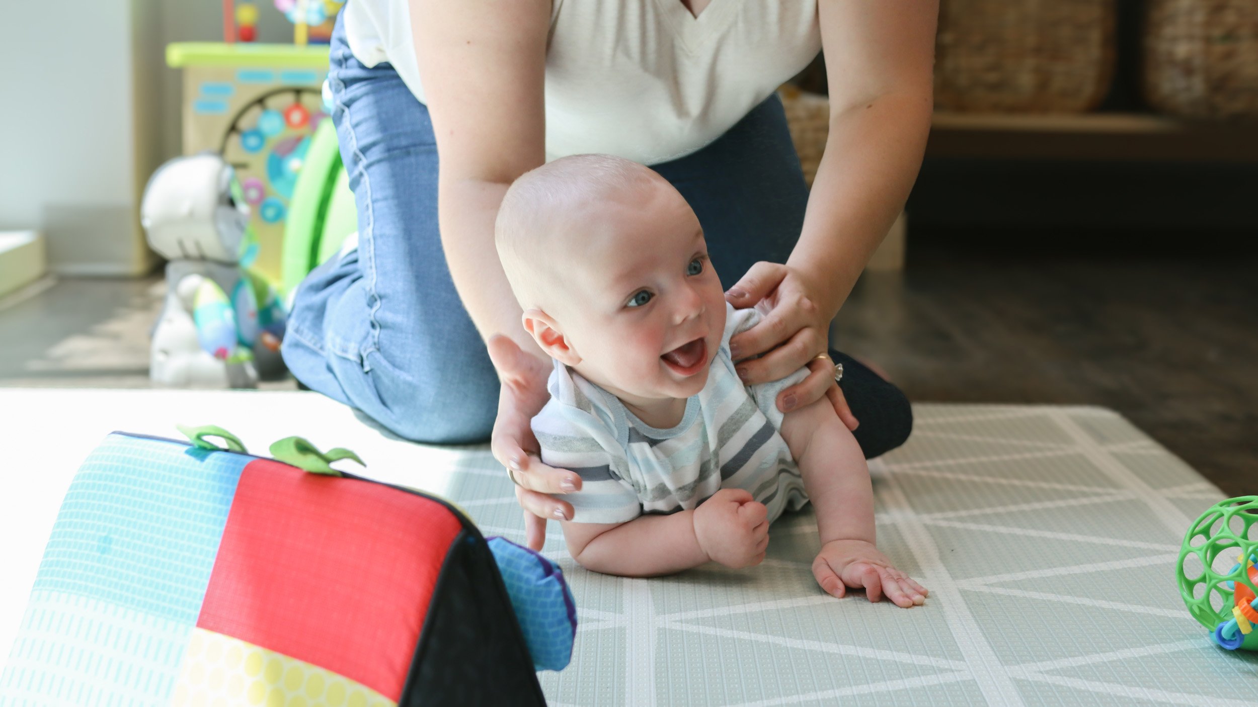 A baby works on rotating with one of the pediatric physical therapist at Looking Ahead's office in Franklin, TN