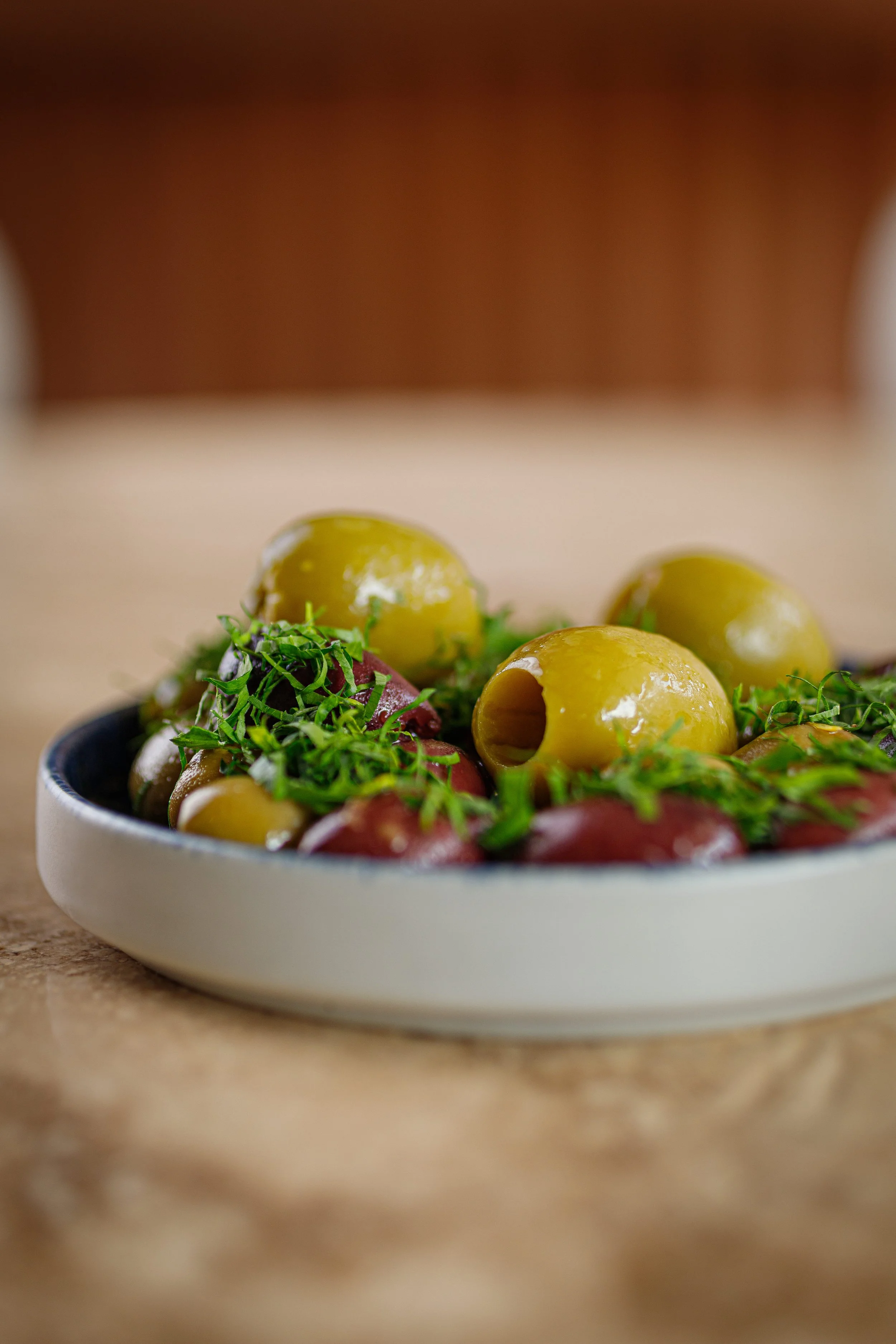 Olives, meyer lemon, vemouth, rosemary, bay leaves, olive oil, parsley.