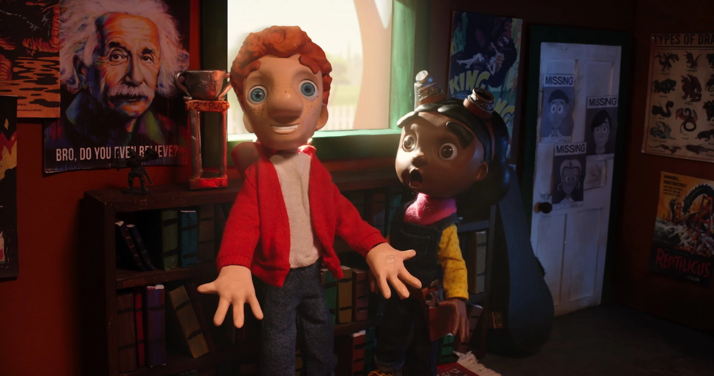 Two puppets with exaggerated facial features stand in a decorated room with posters, books, and a window. One puppet has red hair and an open mouth, the other has dark hair with a surprised expression. Behind them are posters and a door with 'Missing' notices.
