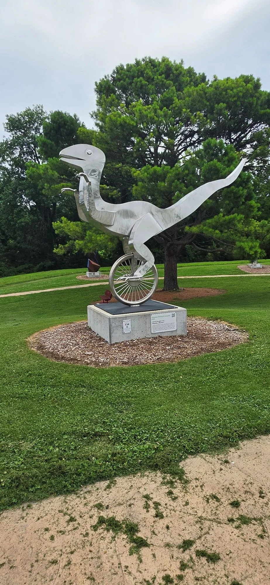 A picture of raptor on a unicycle found along the bluebird trail in Bella Vista