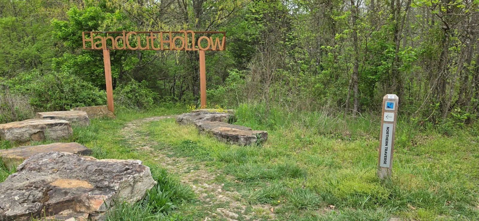 A Picture of the Entrance to Handcut Hollow marked by a large sign riders have to ride under as they enter the Norther Traverse Trail