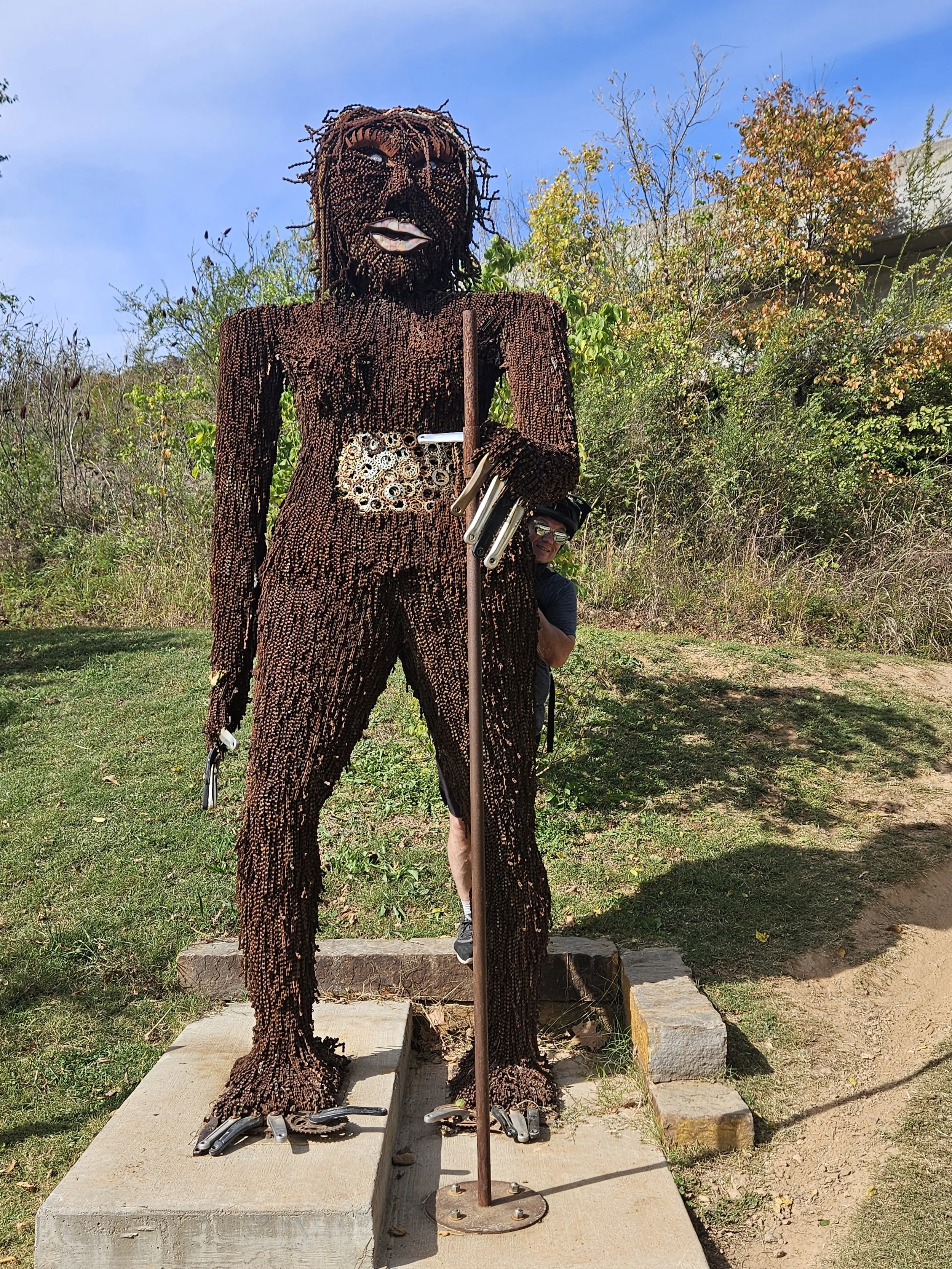 This statue is made up of bike chains, cassettes, pedal cranks and other bike parts that have been put together to resemble a sasquatch