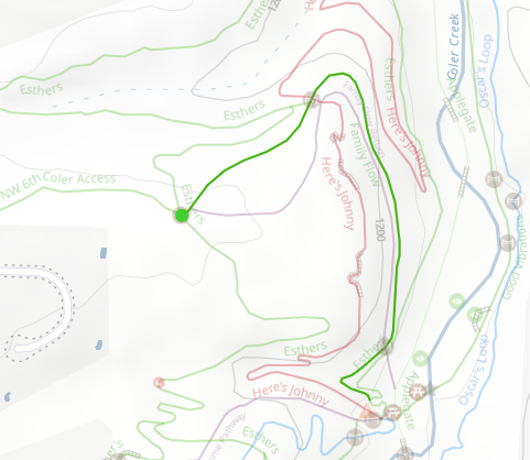 Trail map showing different trails in a park with paths marked in green, pink, and blue, and elevation lines.